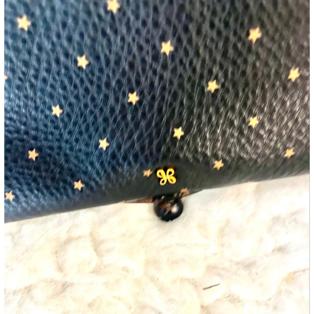 Hobo Wayfare wristlet in black pebbled leather with gold stars
